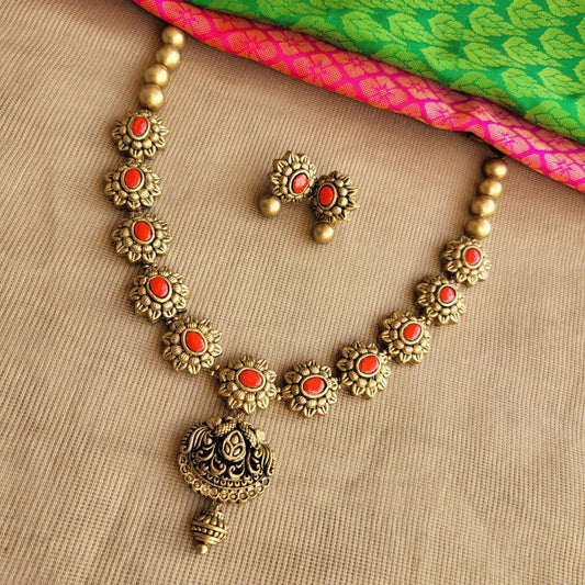 Bavya - Orange Antique gold floral motif necklace with peacock pendant terracotta jewellery with matching earrings