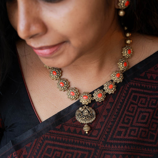 Bavya - Orange Antique gold floral motif necklace with peacock pendant terracotta jewellery with matching earrings