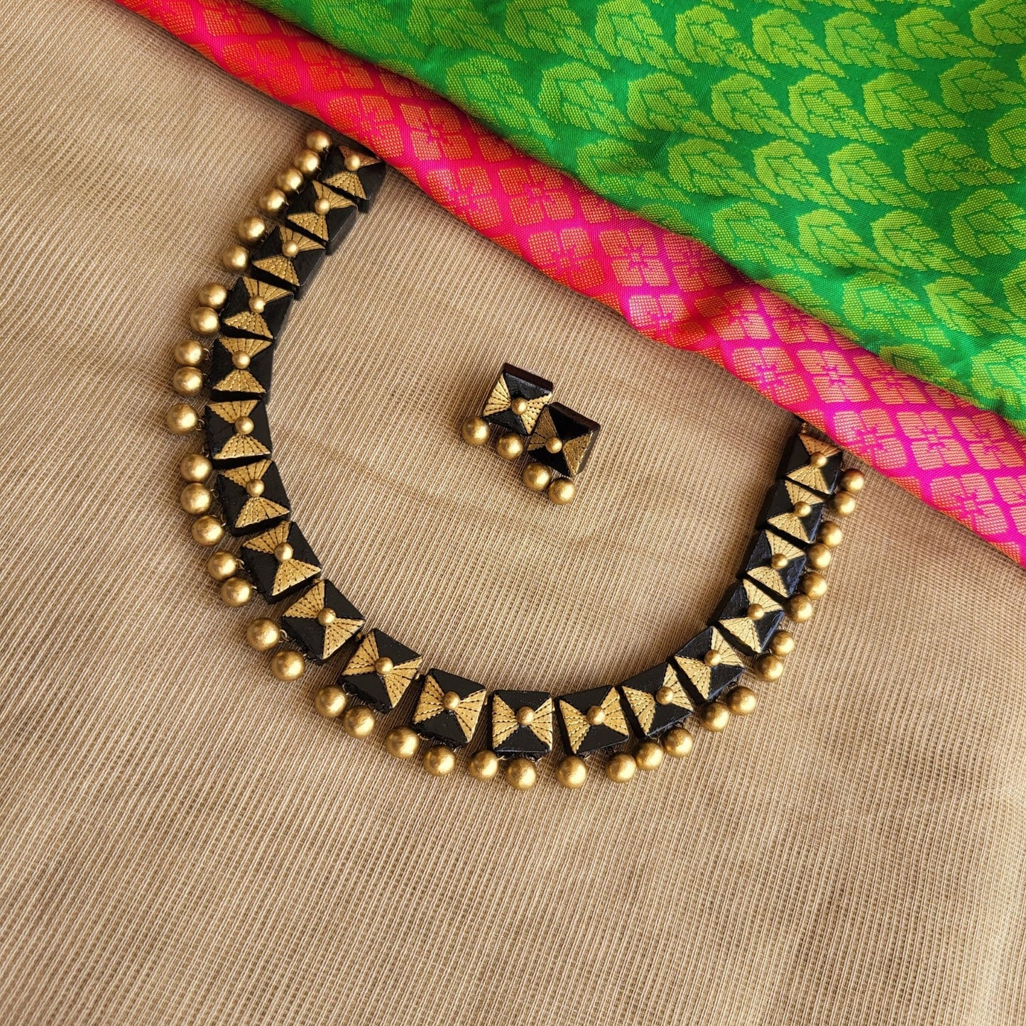 Black and gold square terracotta necklace close-up