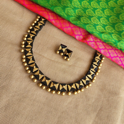 Black and gold square terracotta necklace close-up