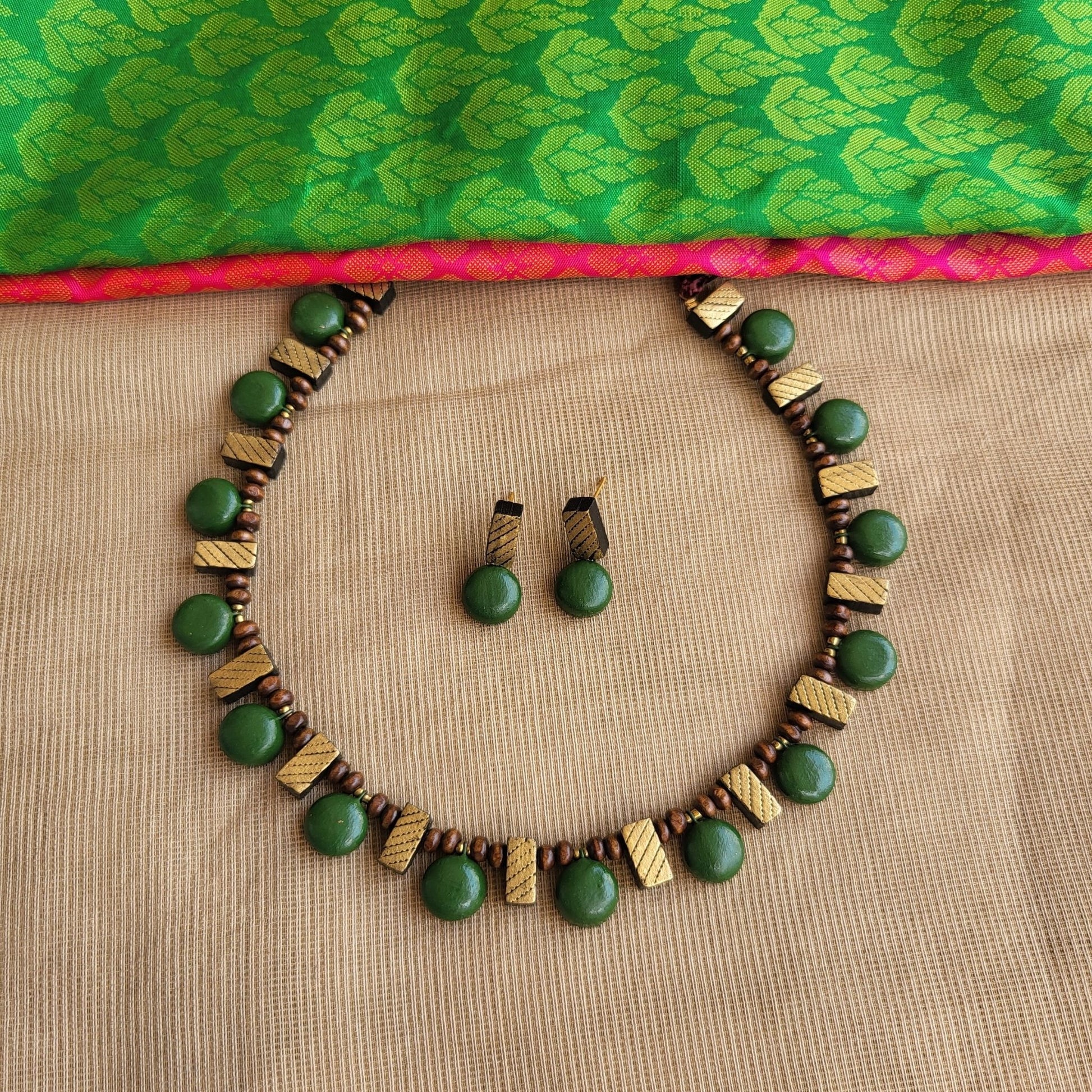 Lightweight handmade terracotta necklace with intricate green and gold design