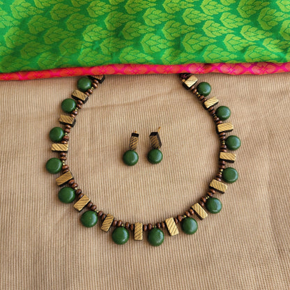 Lightweight handmade terracotta necklace with intricate green and gold design