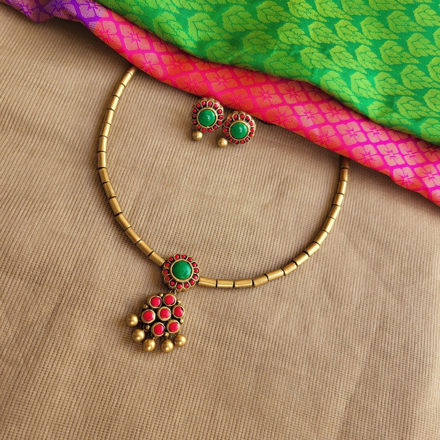 Hand-painted floral terracotta tube design close-up