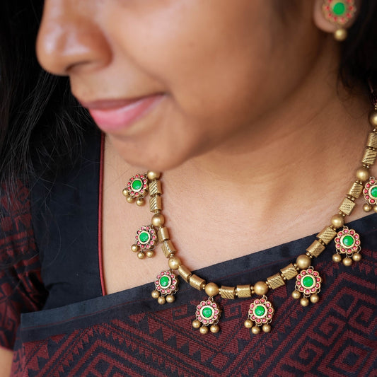 Kavyam handmade terracotta necklace and earrings with red and green floral motifs