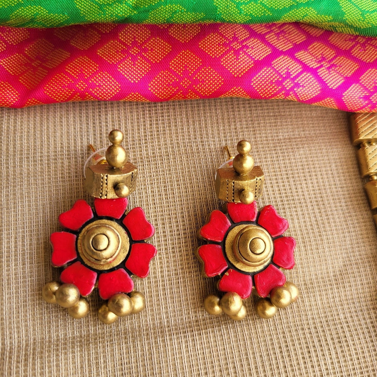 Red floral motif with tube detailing