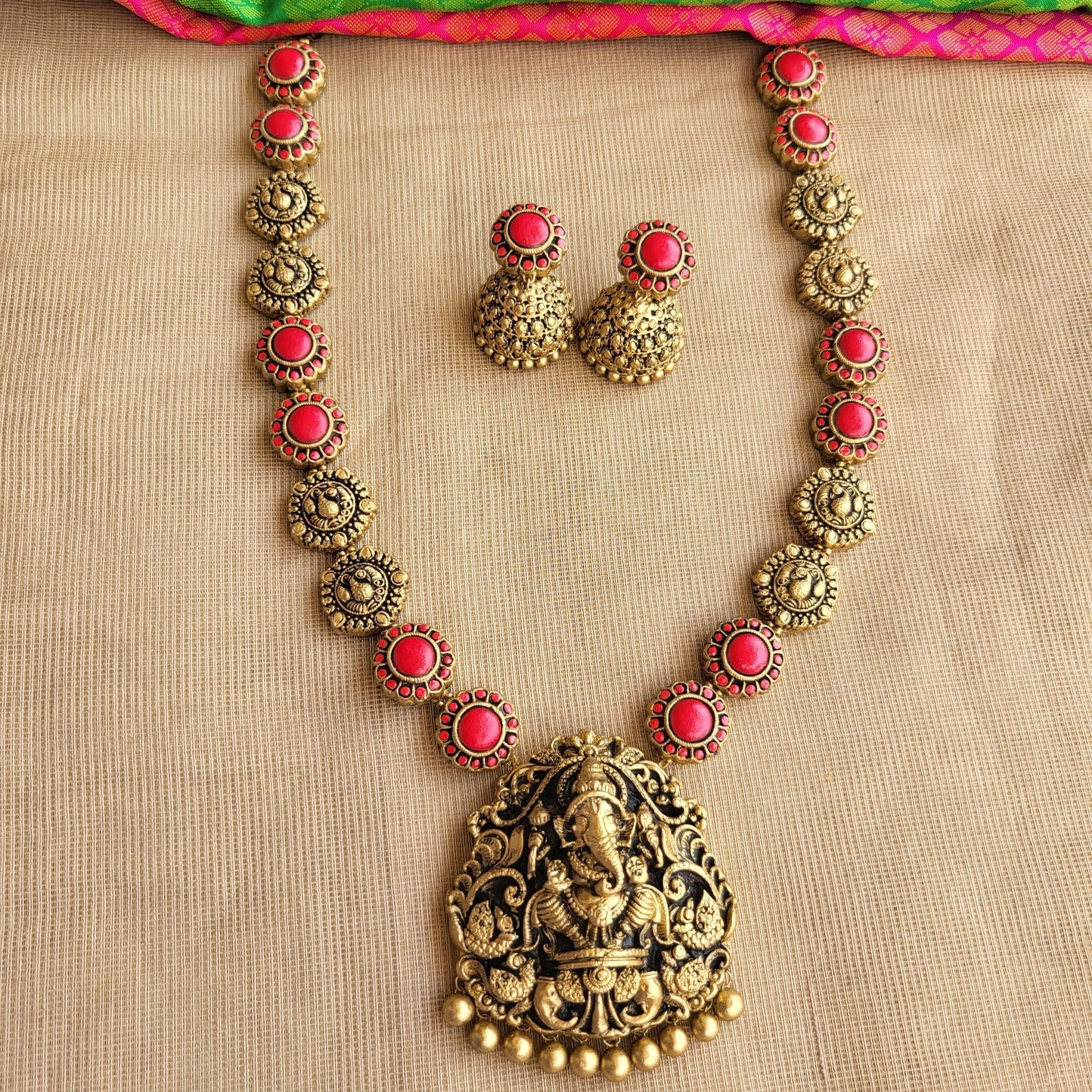 Handcrafted Ganesha pendant with red floral accents