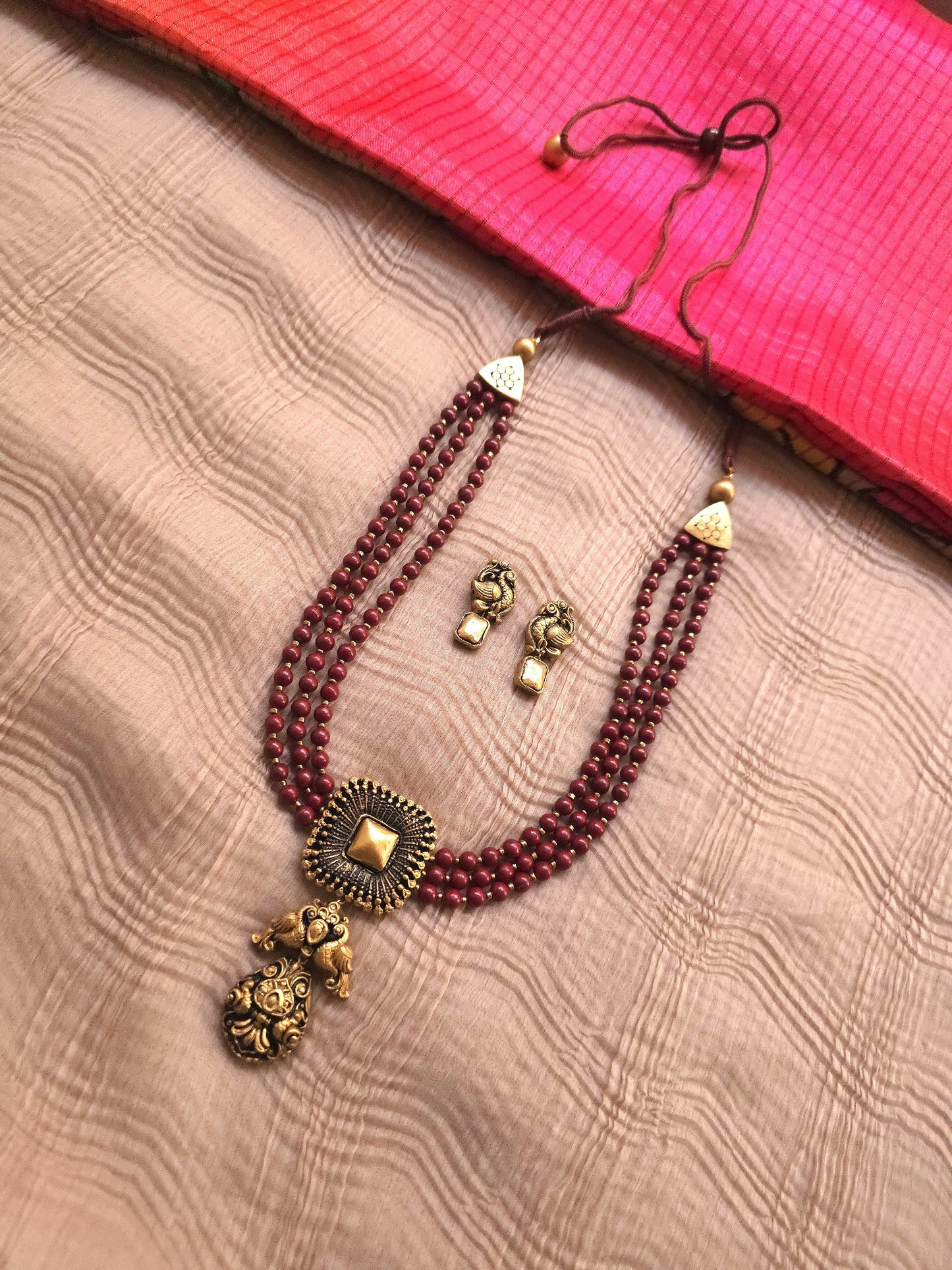Mayura Antique Gold Peacock Emblem & Three-Layer Crimson Terracotta Set