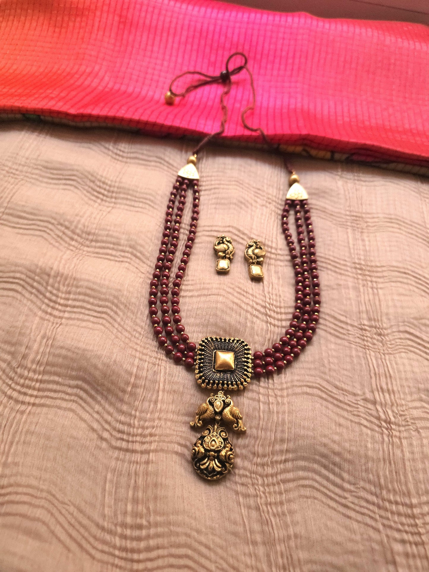 Mayura Antique Gold Peacock Emblem & Three-Layer Crimson Terracotta Set