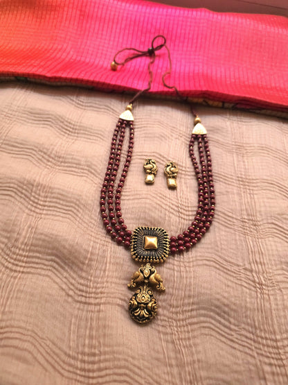 Mayura Antique Gold Peacock Emblem & Three-Layer Crimson Terracotta Set