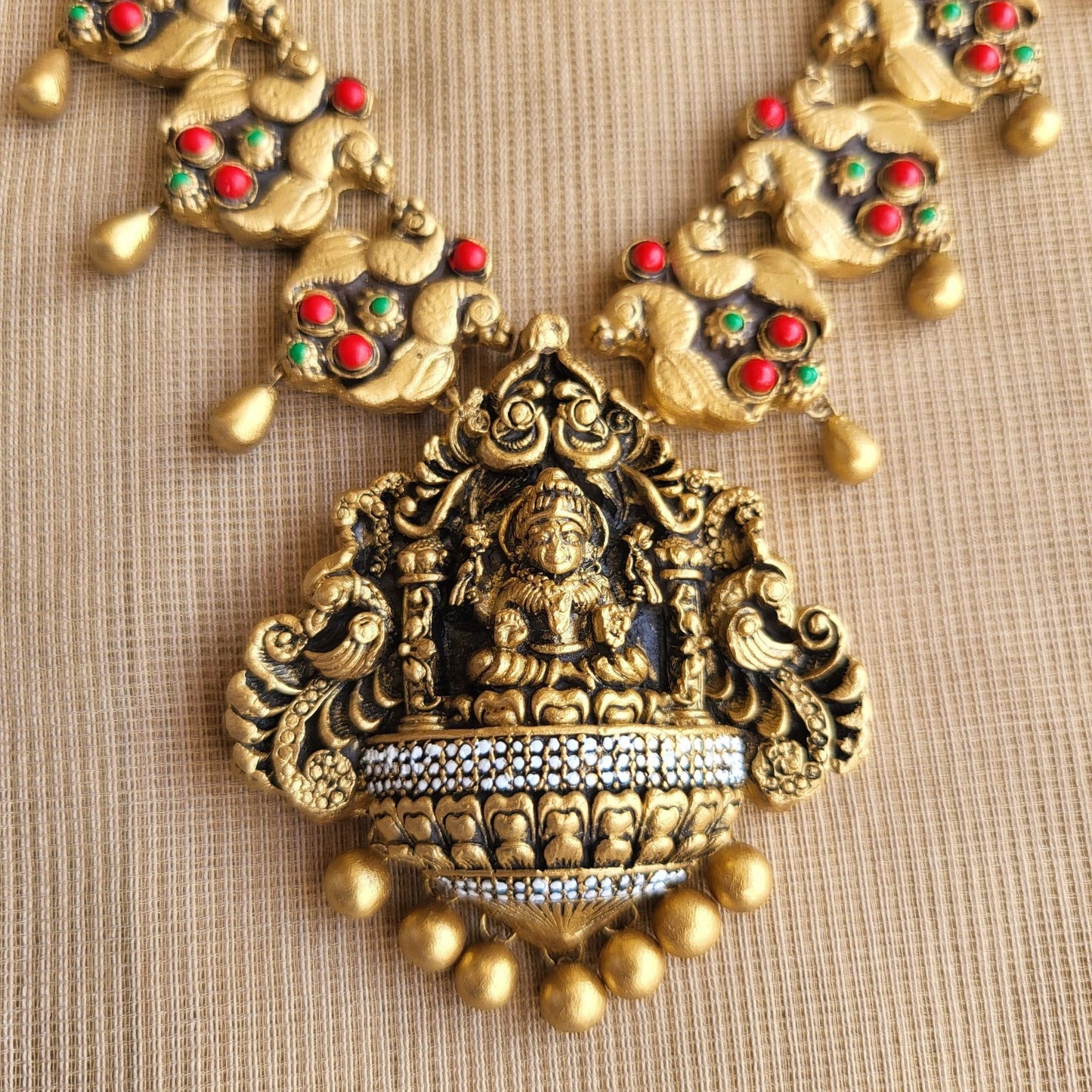 Matching terracotta jumka earrings peacock motif