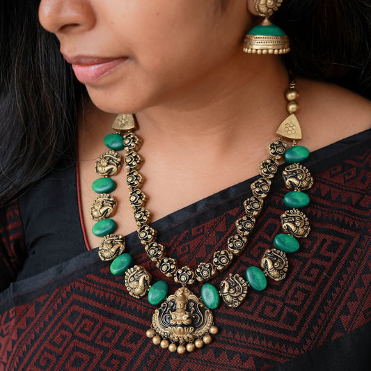 Nayra - Double line antique gold peacock and green oval necklace with Lakshmi pendant with matching jumkas
