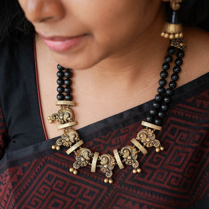 Nerthya terracotta dual-row necklace black antique gold peacock pendant