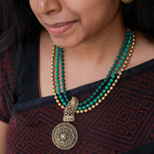 Prahita- Three row beaded necklace in antique gold and green hue with contemporary mandala pendant terracotta jewellery with matching studs