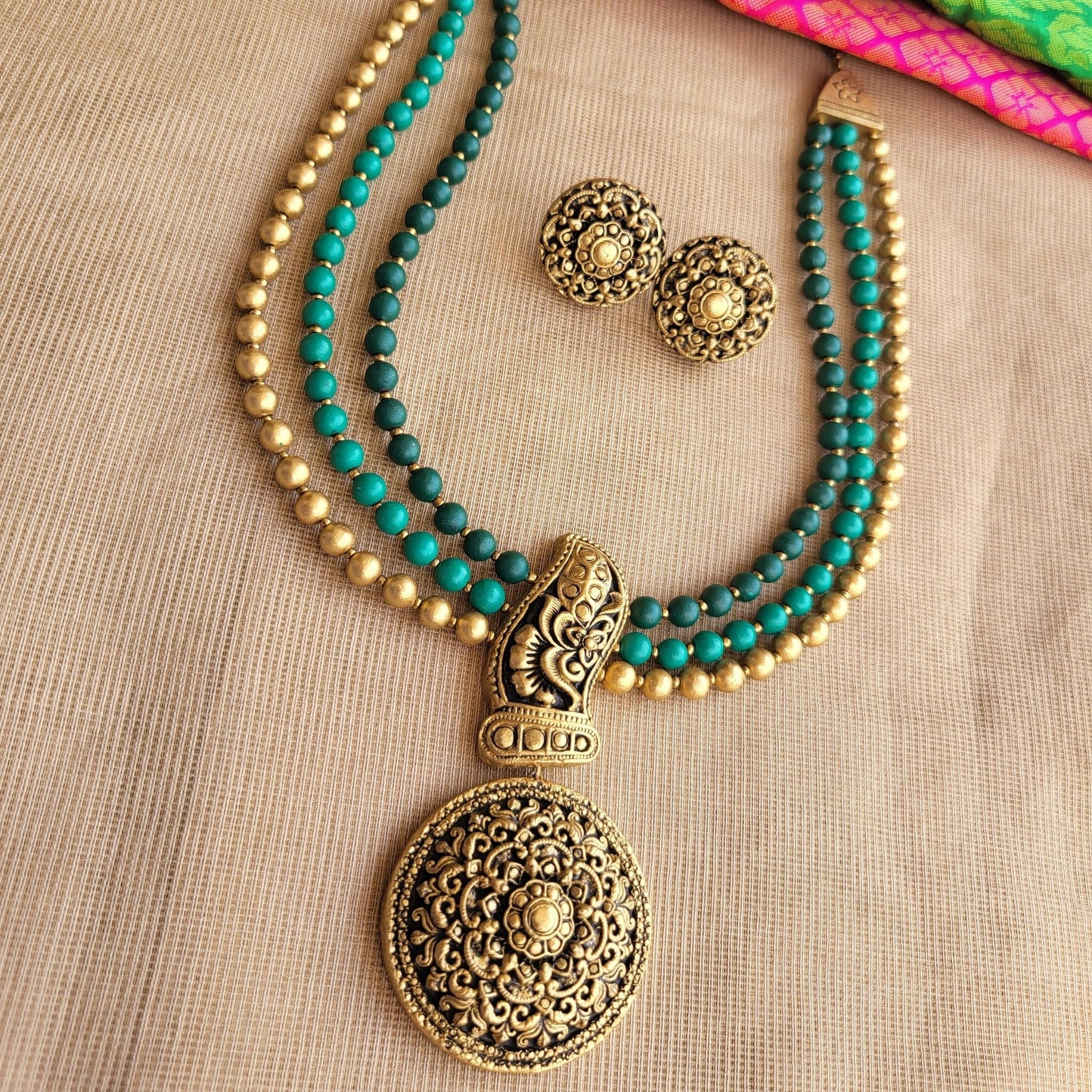 Three-row terracotta necklace with green and antique gold beads