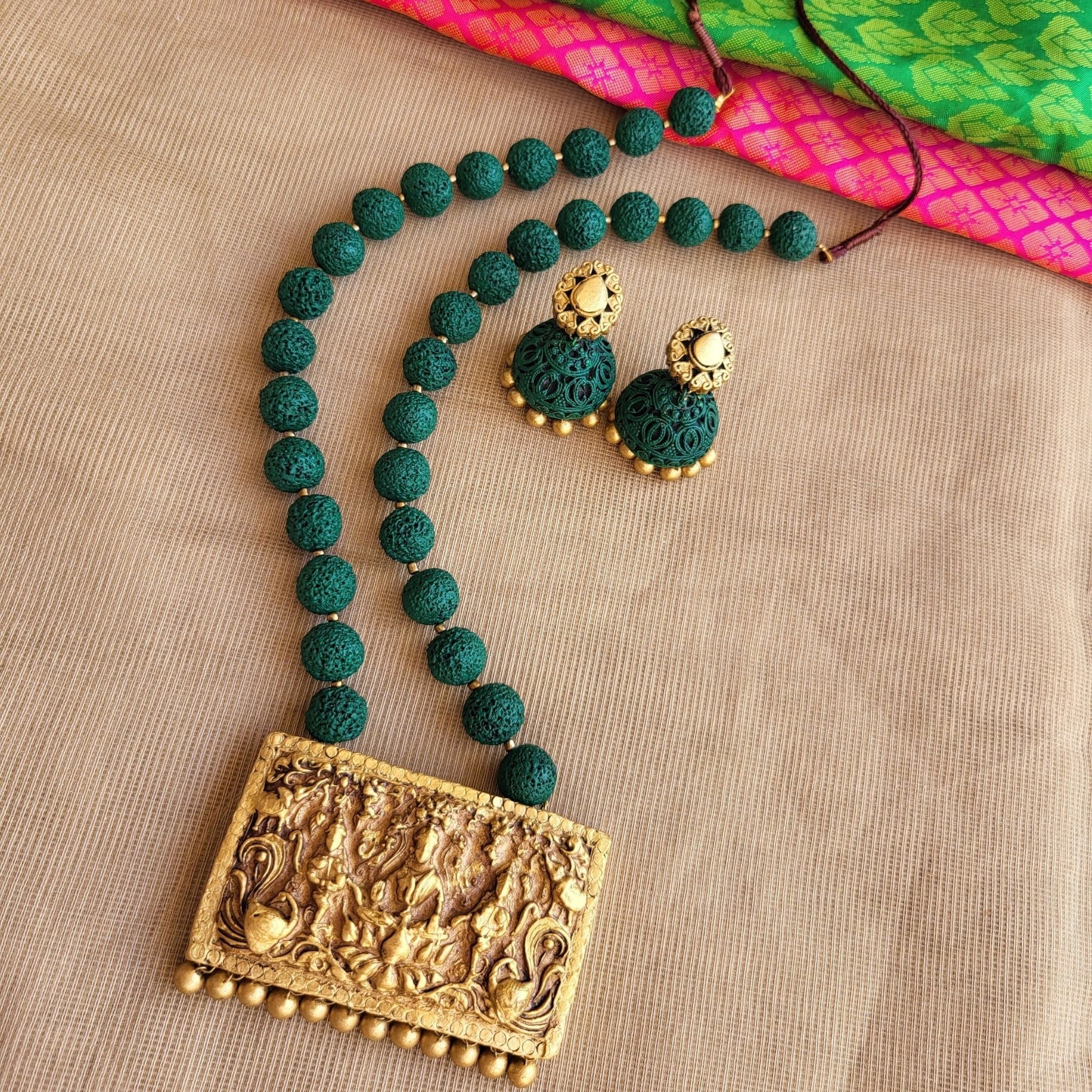 Handmade terracotta pendant with green rudraksh beads