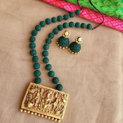 Handmade terracotta pendant with green rudraksh beads