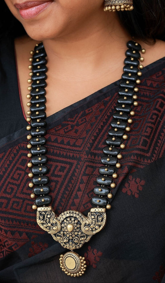 Thaarika - Antique contemporary pendant with black oval motifs terracotta long necklace with matching jumkas