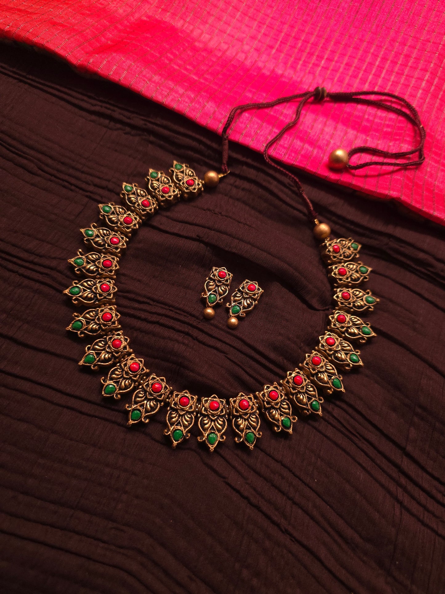 The Kirti Mukha Antique Gold & Tri-Color Floral Crest Terracotta Set