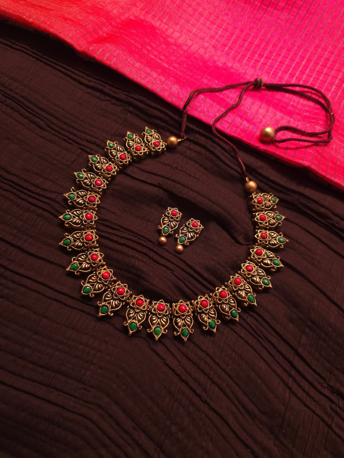 The Kirti Mukha Antique Gold & Tri-Color Floral Crest Terracotta Set