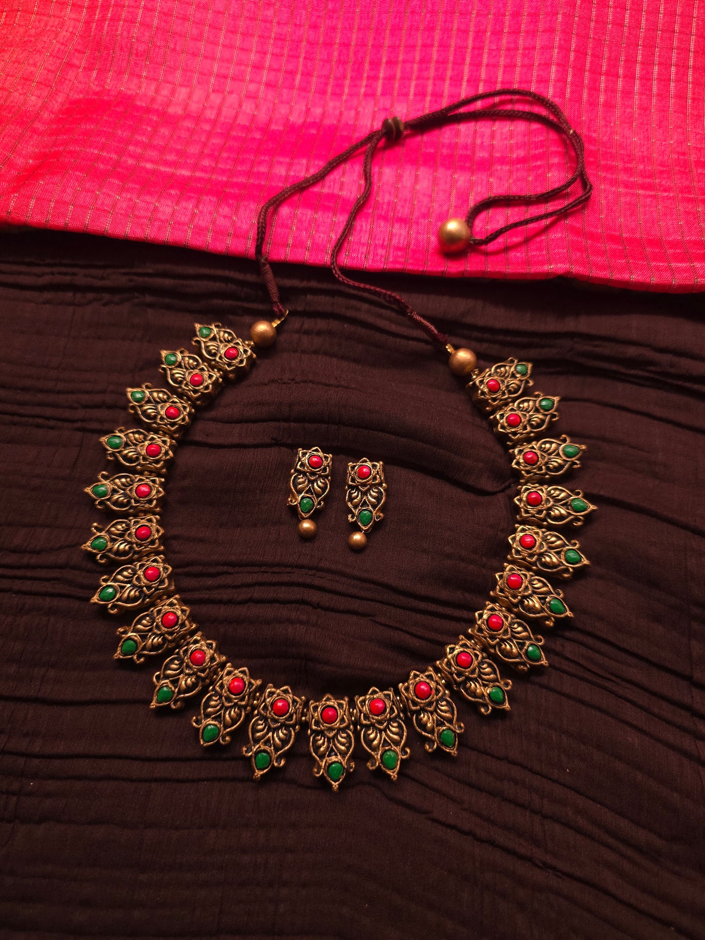 The Kirti Mukha Antique Gold & Tri-Color Floral Crest Terracotta Set