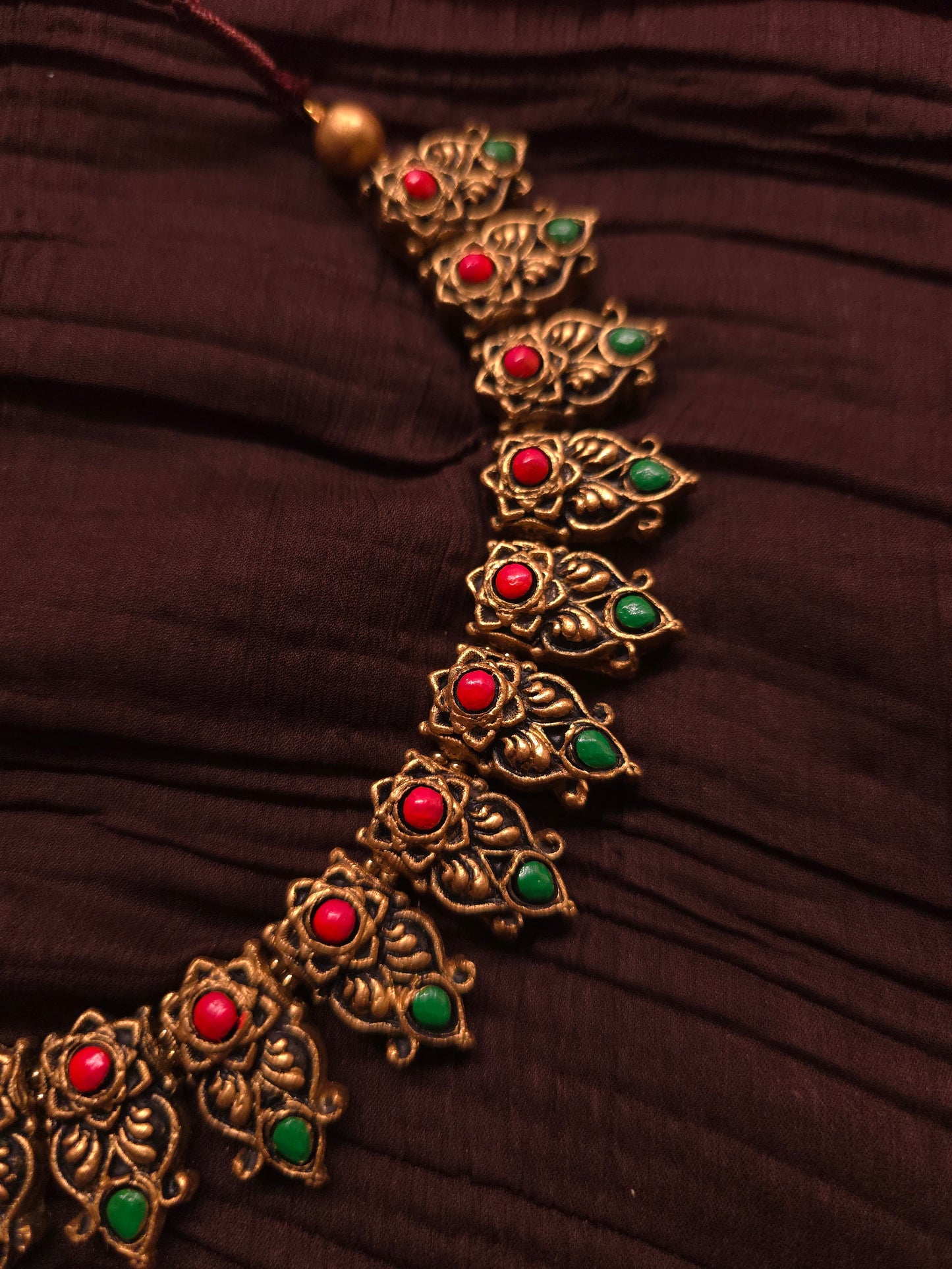 The Kirti Mukha Antique Gold & Tri-Color Floral Crest Terracotta Set