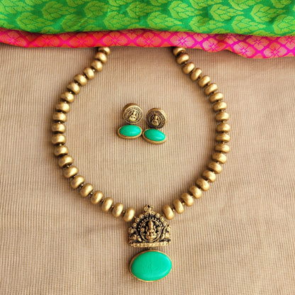 Terracotta Lakshmi pendant with green oval centerpiece