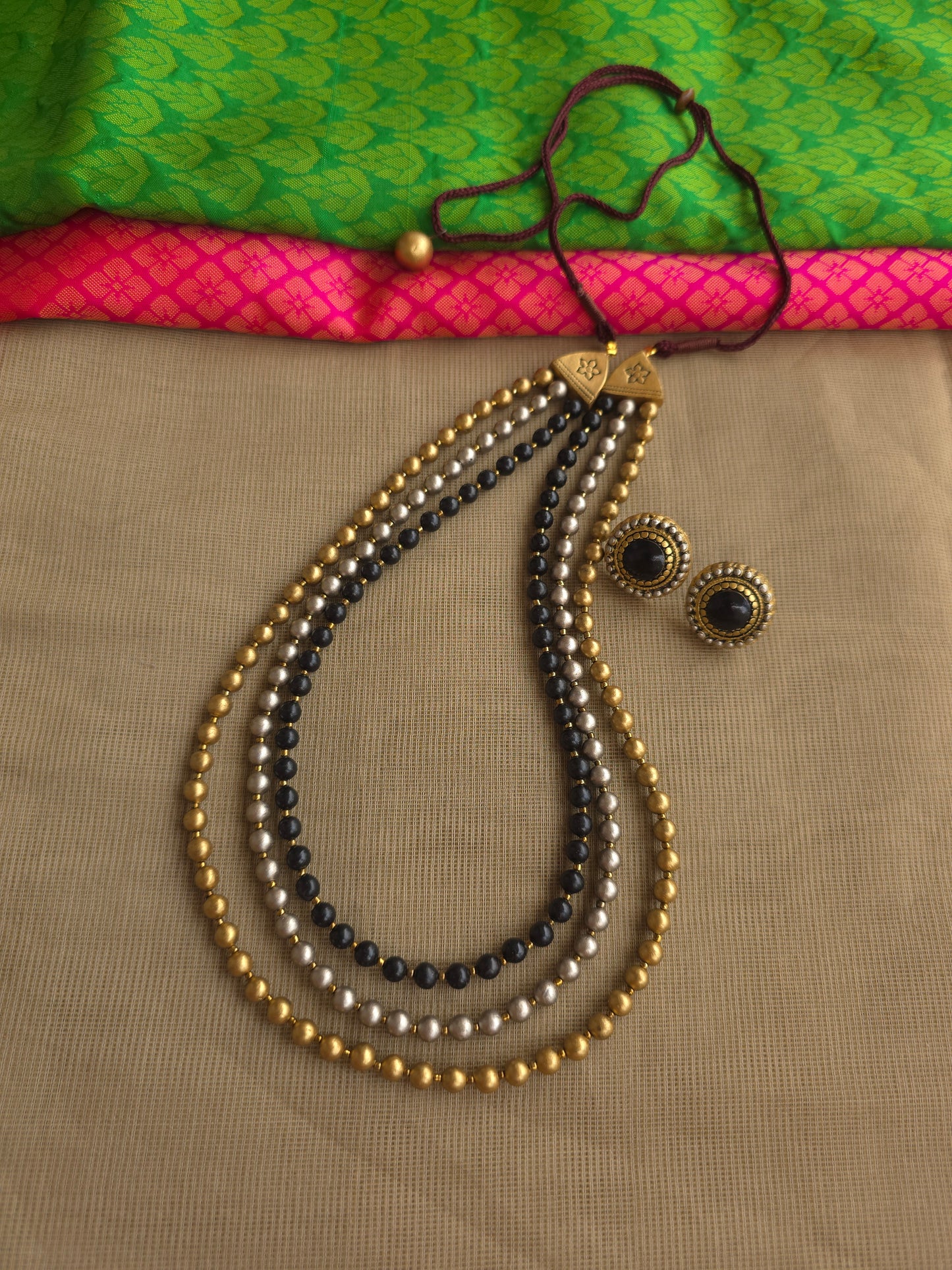 Handmade terracotta bead necklace with gold black silver tones