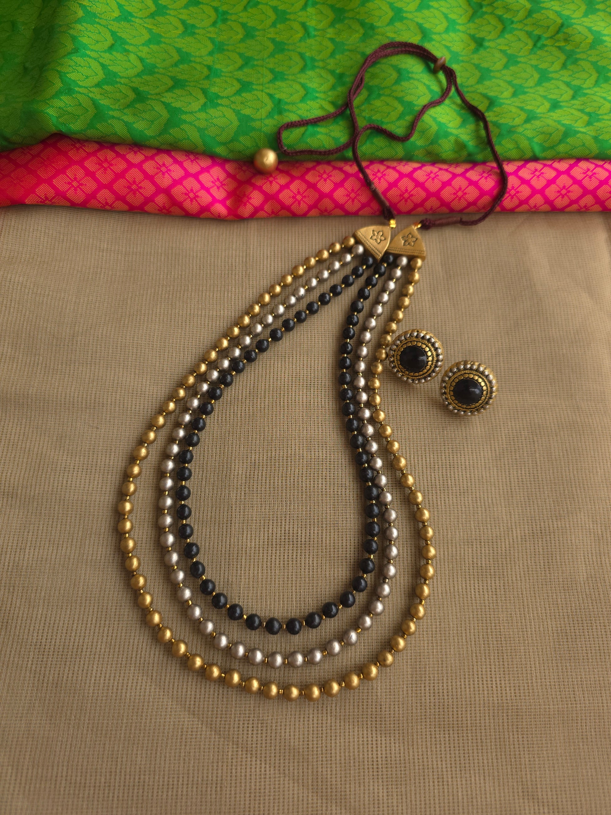 Handmade terracotta bead necklace with gold black silver tones